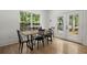 Cozy dining room with hardwood floors, wooden table, and backyard views through large window at 1260 Old Whitesville Rd, Moncks Corner, SC 29461