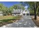 Attractive home featuring a long driveway, a two-car garage, and mature trees at 1260 Old Whitesville Rd, Moncks Corner, SC 29461