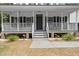 Inviting front porch with classic white railings and an entryway with a dark-colored front door at 1260 Old Whitesville Rd, Moncks Corner, SC 29461