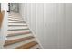Elegant staircase featuring hardwood treads, white risers, and modern railing at 1260 Old Whitesville Rd, Moncks Corner, SC 29461