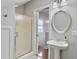 Modern bathroom features a glass enclosed shower, pedestal sink, and tiled floors at 127 Beresford Creek St, Daniel Island, SC 29492