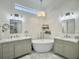 Elegant bathroom featuring dual vanities, a freestanding tub, and shiplap walls at 127 Beresford Creek St, Daniel Island, SC 29492