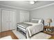 Neutral bedroom with hardwood floors, plush rug, ceiling fan, and classic white trim at 127 Beresford Creek St, Daniel Island, SC 29492