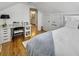 Bright bedroom featuring a built-in desk, hardwood floors, and a glimpse into the adjoining bathroom at 127 Beresford Creek St, Daniel Island, SC 29492
