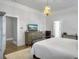 Elegant bedroom with a chandelier, a modern dresser with a TV, and neutral tones at 127 Beresford Creek St, Daniel Island, SC 29492