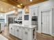 Bright kitchen featuring white cabinets, an island with seating, and modern appliances at 127 Beresford Creek St, Daniel Island, SC 29492