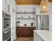 Kitchen area featuring stainless steel appliances, a wine rack, and custom cabinets at 127 Beresford Creek St, Daniel Island, SC 29492