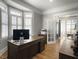 Home office with hardwood floors, a large desk, and plenty of natural light at 127 Beresford Creek St, Daniel Island, SC 29492