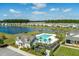 Aerial view of a community pool, lake, and homes, offering a serene and luxurious living environment at 127 Surfbird Rd, Summerville, SC 29486
