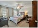 Guest bedroom includes wood furnishings, ceiling fan, and work desk for a private space at 127 Surfbird Rd, Summerville, SC 29486