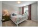 Cozy bedroom with pink accent wall, white furniture, and a charming window with mauve curtains at 127 Surfbird Rd, Summerville, SC 29486