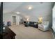 Large carpeted bonus room with sofa, lounger, and toys is perfect for entertaining at 127 Surfbird Rd, Summerville, SC 29486