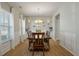 Formal dining room with a chandelier, wainscoting, and large windows, perfect for entertaining guests at 127 Surfbird Rd, Summerville, SC 29486
