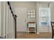 Inviting foyer with stylish decor, a decorative mirror display, and a staircase, offering a warm welcome at 127 Surfbird Rd, Summerville, SC 29486