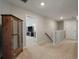 Upstairs hallway featuring a cabinet, and view to den with TV; carpeted with neutral paint at 127 Surfbird Rd, Summerville, SC 29486