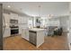 Open-concept kitchen with white cabinets, stainless steel appliances, and views into the living room at 127 Surfbird Rd, Summerville, SC 29486