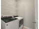 Practical laundry room featuring a modern washer and dryer with overhead shelving at 127 Surfbird Rd, Summerville, SC 29486