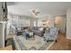 Spacious living room features a cozy fireplace, large windows, and stylish decor, creating an inviting atmosphere at 127 Surfbird Rd, Summerville, SC 29486