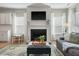 Cozy living room features a fireplace, TV, modern furniture, and bright natural light at 127 Surfbird Rd, Summerville, SC 29486