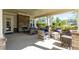 Inviting covered patio featuring an outdoor fireplace and comfortable seating area at 127 Surfbird Rd, Summerville, SC 29486