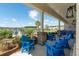 Relaxing patio area with bright blue Adirondack chairs overlooking a pool and serene landscape at 127 Surfbird Rd, Summerville, SC 29486