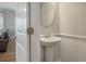 Charming powder room with a pedestal sink and decorative wainscoting, viewed from doorway at 127 Surfbird Rd, Summerville, SC 29486