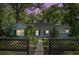 Charming single-story home at dusk with landscaped yard and black metal fence, evoking a sense of warmth at 1316 Wichman St, Walterboro, SC 29488