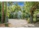 Quaint single-story home featuring lush landscaping, a circular driveway, and ample parking at 1316 Wichman St, Walterboro, SC 29488