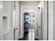 Hallway view showing connected spaces with natural light and hardwood floors at 1316 Wichman St, Walterboro, SC 29488