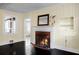 Living room with a fireplace, dark hardwood floors and bright yellow walls at 1316 Wichman St, Walterboro, SC 29488