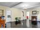 Living room with fireplace, shiny black floors, and views into other rooms at 1316 Wichman St, Walterboro, SC 29488