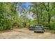 Ample parking area surrounded by mature trees, offering a secluded and private setting at 1316 Wichman St, Walterboro, SC 29488