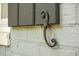 Close-up of charming shutter with decorative hardware accenting the white brick exterior at 1316 Wichman St, Walterboro, SC 29488