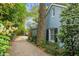 Charming side view of a home featuring a treed driveway and lush landscaping at 1316 Wichman St, Walterboro, SC 29488