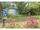Lush garden featuring colorful flowers, a whimsical lawn ornament, and established landscaping at 1316 Wichman St, Walterboro, SC 29488