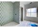 Modern bathroom with green and white tiled shower and natural light at 1430 Hindman Ave, Mount Pleasant, SC 29464