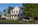 Exterior elevation of a craftsman-style home with a large front porch, showcasing mature landscaping at 1430 Hindman Ave, Mount Pleasant, SC 29464