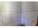 Close-up of white wall with wood paneling and unfinished baseboard at 1430 Hindman Ave, Mount Pleasant, SC 29464