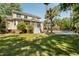 Large backyard with pool, palm trees, and spacious green lawn at 1505 Rivertowne Country Club Dr, Mount Pleasant, SC 29466
