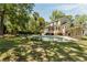 Spacious backyard with a pool, lush green lawn, and mature trees at 1505 Rivertowne Country Club Dr, Mount Pleasant, SC 29466