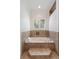 Bright and airy bathroom features a jetted tub with tile surround and window at 1505 Rivertowne Country Club Dr, Mount Pleasant, SC 29466
