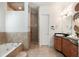 Elegant bathroom features a soaking tub, glass enclosed shower, and dark wood vanity with a white sink at 1505 Rivertowne Country Club Dr, Mount Pleasant, SC 29466
