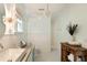 Bright bathroom with wood accents, white tiled walls, and glass chandelier at 1505 Rivertowne Country Club Dr, Mount Pleasant, SC 29466