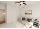 Bright bedroom features a ceiling fan, a comfortable couch, and serene decor, creating a peaceful retreat at 1505 Rivertowne Country Club Dr, Mount Pleasant, SC 29466