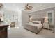 Bright primary bedroom featuring neutral decor, patterned wallpaper, and multiple windows for abundant natural light at 1505 Rivertowne Country Club Dr, Mount Pleasant, SC 29466