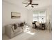 Bedroom with ceiling fan, couch, and desk, creating a versatile space for relaxation and productivity at 1505 Rivertowne Country Club Dr, Mount Pleasant, SC 29466