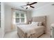 Bright bedroom featuring tufted headboard, ceiling fan, and ample natural light at 1505 Rivertowne Country Club Dr, Mount Pleasant, SC 29466