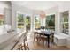 Cozy breakfast nook with lots of light from multiple windows and stylish pendant light fixture at 1505 Rivertowne Country Club Dr, Mount Pleasant, SC 29466