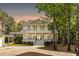 Stately two-story home with dual balconies and a charming, inviting facade at 1505 Rivertowne Country Club Dr, Mount Pleasant, SC 29466