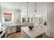 Modern white kitchen with stainless steel appliances, large island, and plenty of counter space for cooking at 1505 Rivertowne Country Club Dr, Mount Pleasant, SC 29466